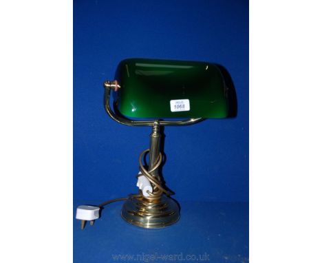 A brass Desk Lamp with green glass shade.