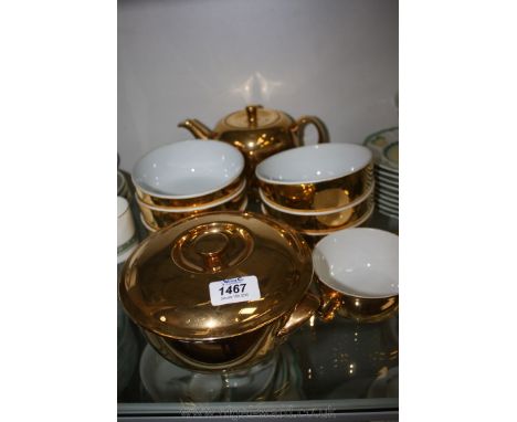 A Royal Worcester gold lustre Teapot, Casserole, six Bowls and a soup coup.