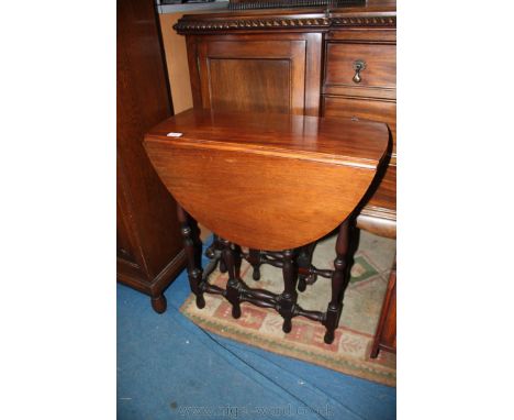 A modern Mahogany gate-leg dropleaf Occasional Table, having rectangular top with demi-lune leaves, standing on turned legs a