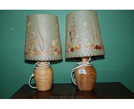 A pair of turned ash Table Lamp Bases by Maureen and Keith Shambrook, Wales with pressed flower shades.