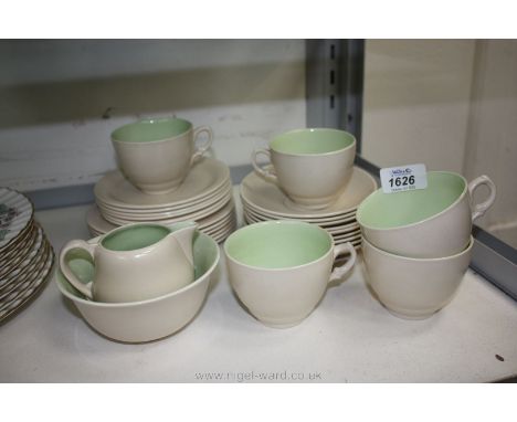 A quantity of Clarice Cliff, cream ground with pale green interior and comprising five cups, nine saucers, twelve small plate