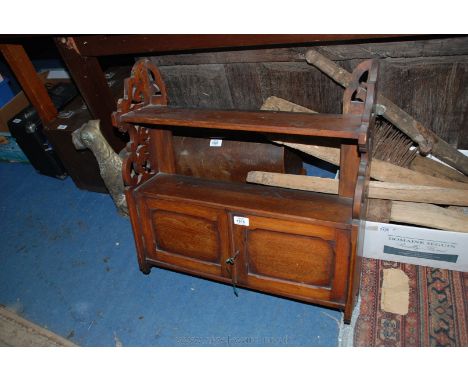 An Edwardian Mahogany Wall Cabinet, having upper shelf on fret-cut and pierced supports, over lower shelf, over pair of oppos