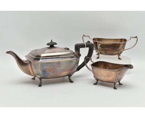 AN EARLY 20TH CENTURY SILVER MASONIC PRESENTATION, THREE PIECE TEA SET, comprising of a teapot, sugar bow and milk jug, facet