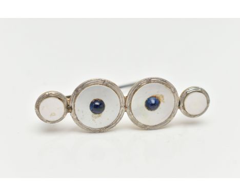 A CONVERSION BROOCH, four mother of pearl white and yellow metal dress studs fitted together, fitted with a base metal pin an