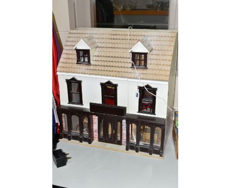 A MODERN KIT BUILT WOODEN DOLLS HOUSE, modelled as a Victorian/Edwardian ground floor shop with rooms above, front opening to