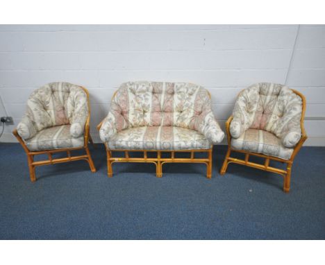 A WICKER THREE PIECE CONSERVATORY SUITE, comprising a two seater sofa and two armchairs (condition report: discoloration to u
