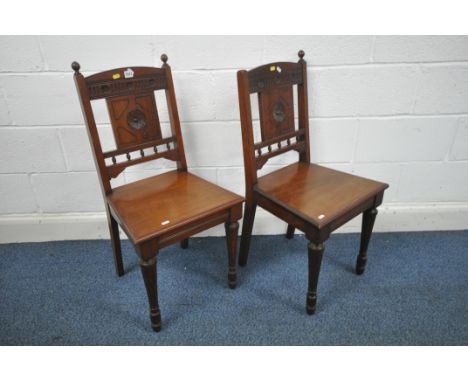 A PAIR OF EDWARDIAN MAHOGANY HALL CHAIRS, with carved detail to backrest, on fluted front legs (condition report: one finial 