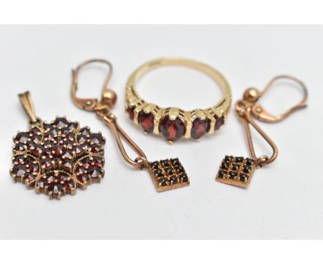 A GARNET SET RING, PENDANT AND EARRINGS, the ring set with five oval cut garnets, leaf detailed shoulders leading onto a poli