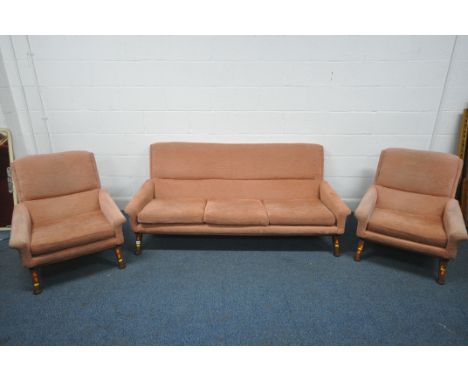 A MID CENTURY SCANDINAVIAN / DANISH THREE PIECE LOUNGE SUITE, with low seat and armrests, upholstered in pink fabric, on shap