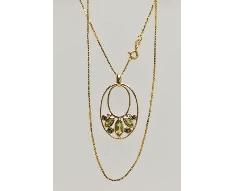A YELLOW METAL GEM SET PENDANT AND A 9CT GOLD CHAIN, the oval open work pendant set with three marquise cut peridots, four sm