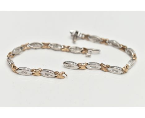 A 9CT GOLD DIAMOND LINE BRACELET, AF designed as an alternating white gold oval links each set with two small single cut diam