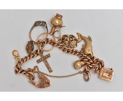 A ROSE METAL CHARM BRACELET, a curb link bracelet, fitted with a heart padlock clasp, stamped 9ct, fitted with seven 9ct gold