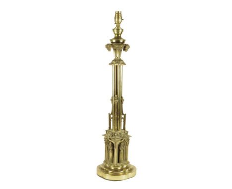 A William IV gilt brass Gothic style table lamp, with a cluster column stem, the base with a female robed figure within an ar