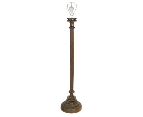 A carved oak standard lamp, with shade, 177cm high, 51cm wide. Provenance: A private collection in the Cotswolds.