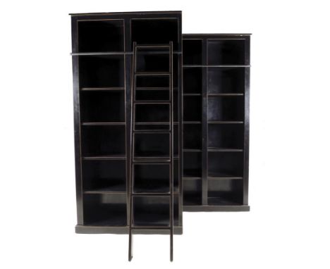 A pair of ebonized open bookcases, each with ten fixed shelves and an integral metal ladder rail, with one ladder, modern, 24