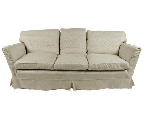 A three seater sofa, upholstered in ivory damask, on shepherd castors, 80cm high, 211.8cm wide, 100cm deep. Provenance: The E