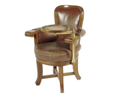A Victorian oak tub armchair, covered with brown leather, one scroll arm with a brass lamp stand.