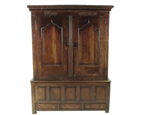 A George II Welsh oak press cupboard, the frieze with two panels carved with initials 'IEO' and with the date '1747', above a