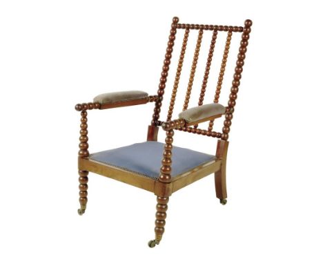 An early 19th century goncalo alves bobbin turned armchair in the manner of Gillows,  on brass caps and castors.