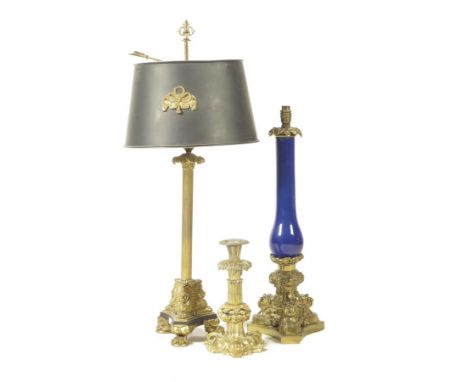A Victorian gilt brass table lamp, with a blue opaque glass baluster stem, on a triform base,  63.4cm high, together with a g