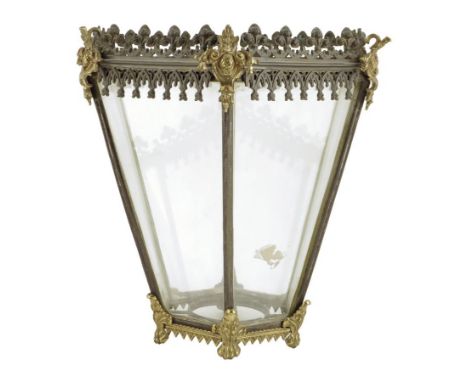 A Regency gilt and patinated brass hexagonal hall lantern, decorated with bands of Gothic tracery, the tapering body on paw f