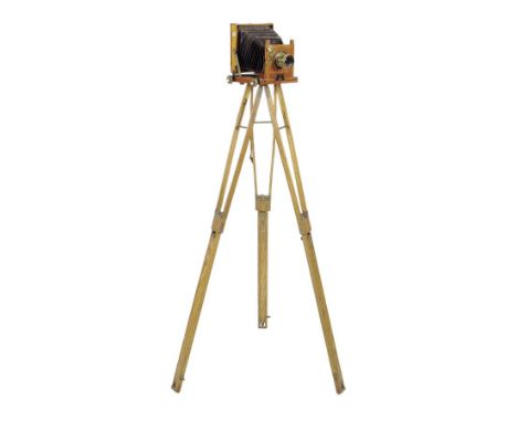 A Thornton Pickard 'Tribune' plate camera, with a brass lens and mounts on an adjustable folding tripod stand, 114.5cm high, 