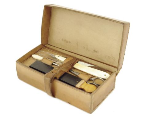 A brown leather cased Campaign toilet set, fitted with a hone, steel scissors, a button hook, a razor, a shaving brush in a b