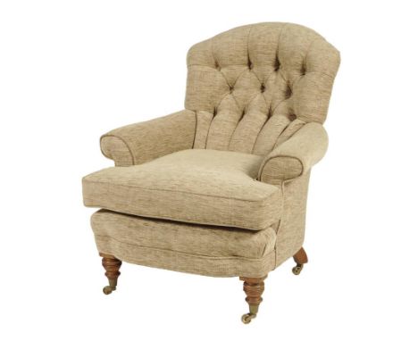 An easy armchair by Howard & Sons Ltd, the button back above scroll arms on walnut legs and brass caps and castors, the back 