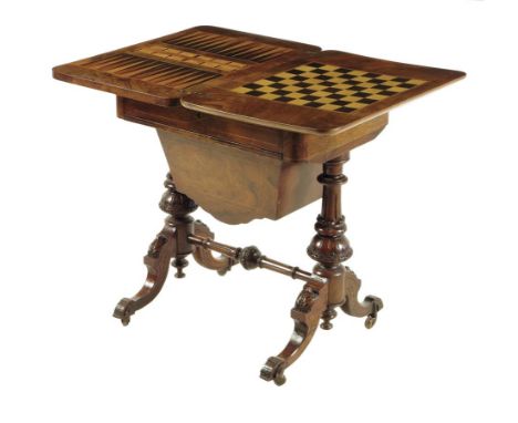 A Victorian walnut games / sewing table, the hinged swivel top inlaid with backgammon, cribbage and chequer boards, above a f