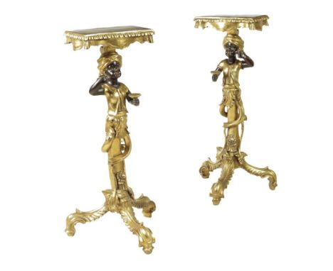 A pair of Venetian style carved and gilt Blackamoor torchères, each with a tasselled top above a figural stem and tripod supp