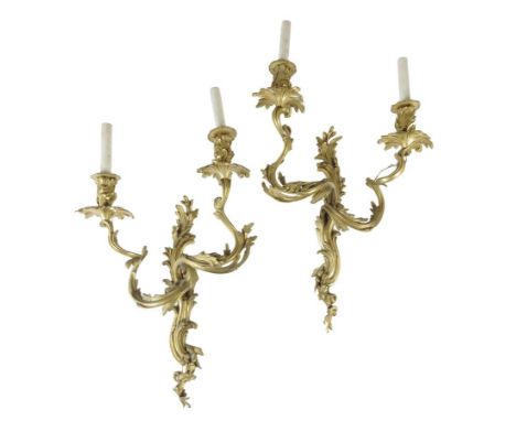 A pair of Louis XV style ormolu twin light wall appliques, each with leaf scroll branches, the back plate stamped 'LG 35', la