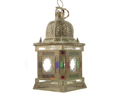 An Ottoman style brass mosque lantern, with pierced decoration and stained glass panels, 54cm high, 23.5cm wide.