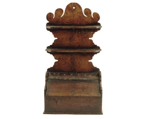 A George III oak hanging spoon rack, with two shelves pierced with twelve apertures, above a hinged sloping box base, 58cm hi