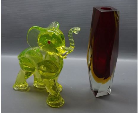 Unsigned studio glass model of an elephant, with red eyes and white glass tusk with raised trunk, together with a further hea