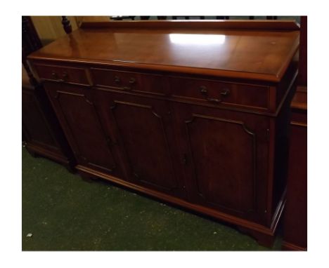 Reproduction yew wood dresser base with three drawers over three panelled cupboard doors, on bracket feet, swan neck handles,