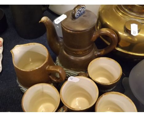 Quimper ware coffee set with brown ground and blue geometric border, comprising coffee pot, two milk jugs, six cups and sauce