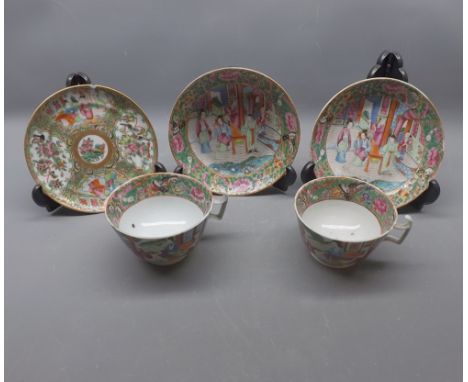 Pair of large 19th century famille rose decorated tea cups and saucers with multi-coloured scenes, together with a non-matchi