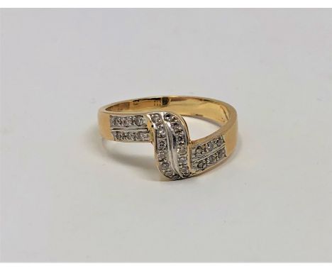 An 18ct gold diamond set crossover ring, size K1/2.  CONDITION REPORT: 3.6g. 