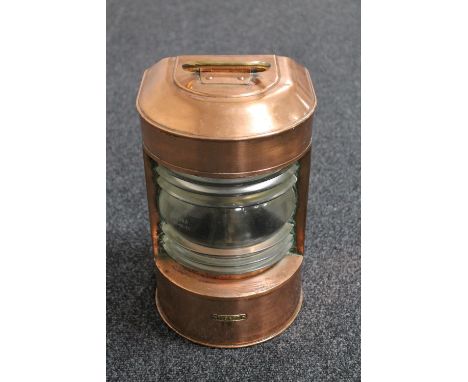 An antique brass and copper ship's lamp 