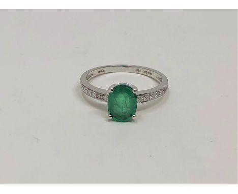 A 14ct white gold emerald and diamond ring, the emerald weighing 0.99 carat, the diamonds 0.16 carat, size L. With certificat