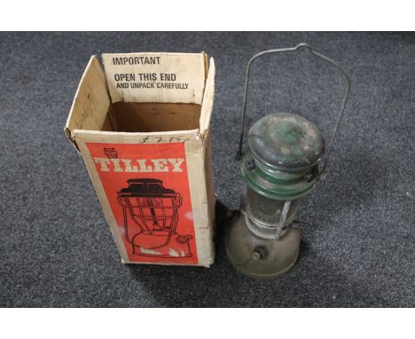 A boxed Tilley storm light 