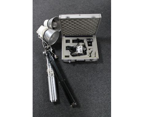 An aluminium case containing Ricoh KR-5 camera with accessories together with two photographic lamps 