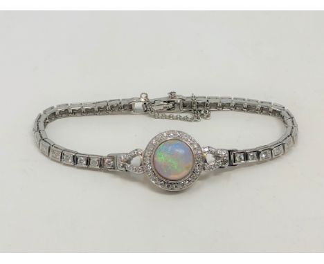 A 14ct white gold opal and diamond bracelet, the Australian cabochon opal weighing 3.14 carats, seventy brilliant-cut diamond