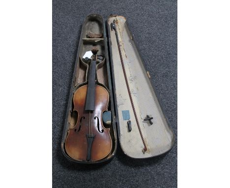 A late 19th century Stradivarius copy violin and bow in case (a/f)