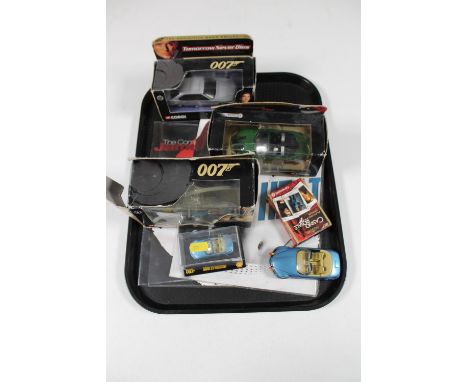 A tray of three boxed 007 Corgi vehicles, two further die cast vehicles, Casino Royale playing cards etc 