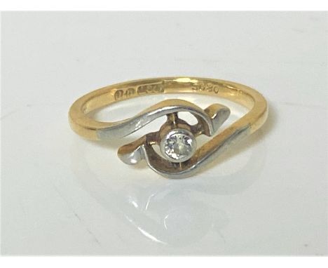 An 18ct gold diamond set crossover ring, size L.  CONDITION REPORT: 2.3g. 