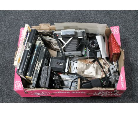 A box of vintage cameras, cameras books, black and white photographs 