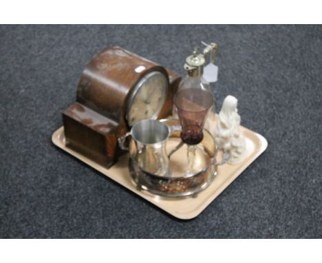 An oak cased mantel clock with silvered dial, an antique etched glass claret jug with plated stag's head lid, glass goblet, r