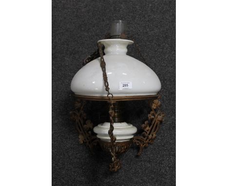 An antique hanging oil lamp with chimney and glass shade 