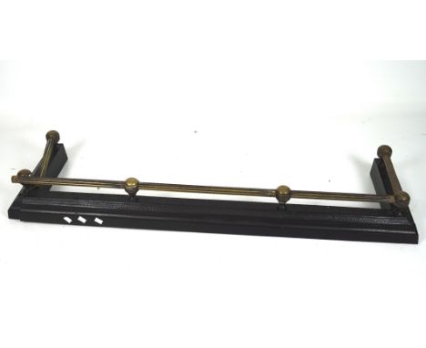 A 19th century cast iron and brass fender, the brass with a fluted design, length circa 135cm (AF)